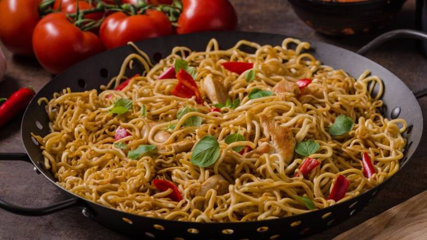 Zdjęcie poglądowe – makaron po chińsku z kurczakiem w czarnej misce.